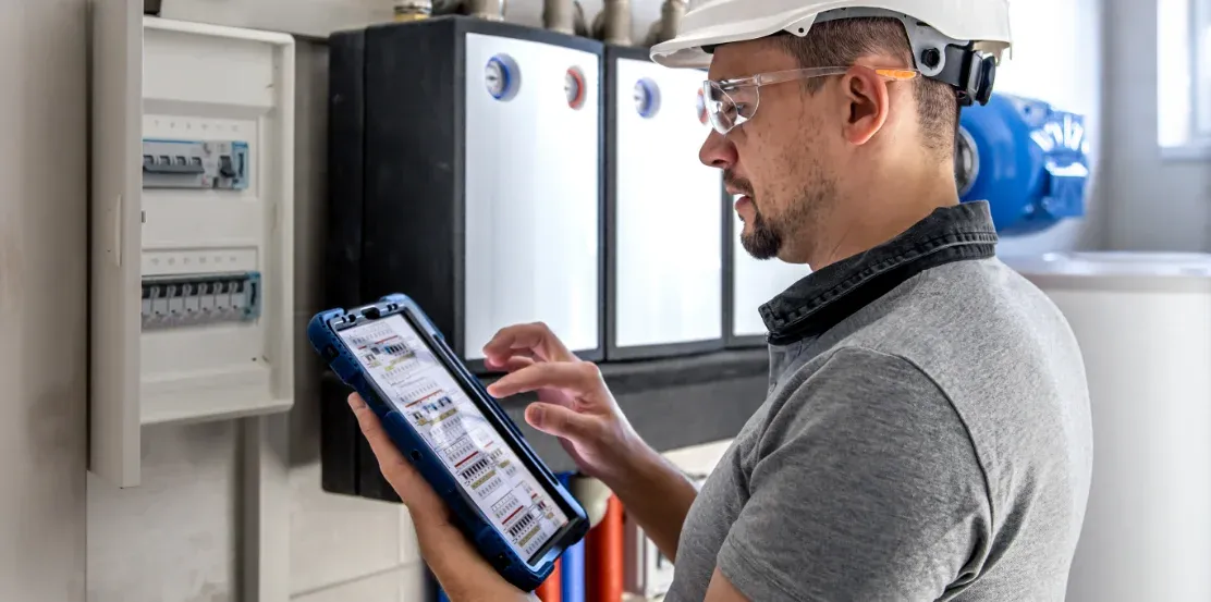 Technician checking a meter with AI in property management for maintenance