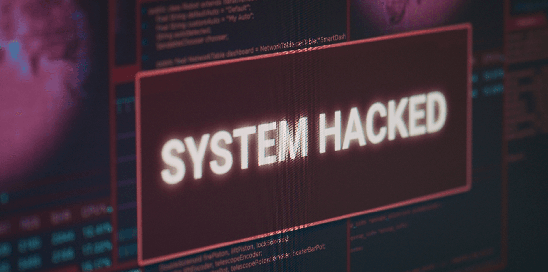 Monitor screen showing hacked alert on third-party data breach