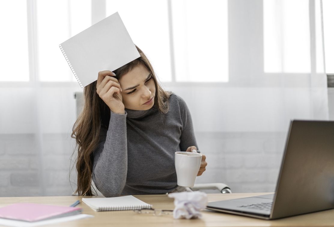 A woman stressed with paperwork due to manual asset tracking